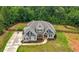 Beautiful two-story home on a spacious lot, featuring lush landscaping, a long driveway, and privacy fence at 7532 Milford Pl, Douglasville, GA 30135