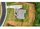 Overhead view of a two-story home with lush lawn, long driveway, fenced yard and mature landscaping at 7532 Milford Pl, Douglasville, GA 30135