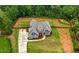 Spacious two-story home on a large fenced lot with a lush green lawn, landscaping, and long driveway at 7532 Milford Pl, Douglasville, GA 30135