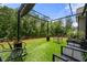 Relaxing backyard featuring outdoor seating on a well-maintained artificial turf at 7532 Milford Pl, Douglasville, GA 30135