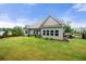 Lush backyard with mature trees, a manicured lawn, and a charming patio area at 7532 Milford Pl, Douglasville, GA 30135