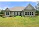 Large backyard with lush green grass, patio area and view of the house's rear exterior at 7532 Milford Pl, Douglasville, GA 30135