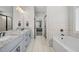 Luxurious Primary bathroom with double sinks, a soaking tub, and a frameless shower at 7532 Milford Pl, Douglasville, GA 30135