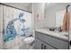 Modern bathroom featuring stylish vanity and tub with mermaid-themed shower curtain at 7532 Milford Pl, Douglasville, GA 30135