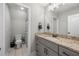Clean and modern bathroom with a granite countertop vanity and a tile-floored toilet room at 7532 Milford Pl, Douglasville, GA 30135