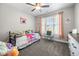 Cozy bedroom with natural light, playful decor, and neutral gray carpet at 7532 Milford Pl, Douglasville, GA 30135