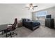 Comfortable bedroom with a ceiling fan, soft carpet, a bed with gray bedding, and a window at 7532 Milford Pl, Douglasville, GA 30135