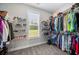 Walk-in closet with ample storage and shelving, providing organization at 7532 Milford Pl, Douglasville, GA 30135