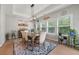Bright dining room features a stylish light fixture, a patterned rug and lots of natural light at 7532 Milford Pl, Douglasville, GA 30135