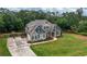 Charming two-story home with a lush green lawn, fenced yard, and long concrete driveway at 7532 Milford Pl, Douglasville, GA 30135