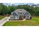 Inviting two-story home with stone accents, manicured landscaping, and a welcoming front porch at 7532 Milford Pl, Douglasville, GA 30135