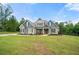 Inviting home exterior with landscaped front lawn, stone accents, and a cozy porch at 7532 Milford Pl, Douglasville, GA 30135