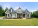 Stunning home with well-maintained lawn, stone facade, and inviting covered entry at 7532 Milford Pl, Douglasville, GA 30135