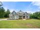 Beautiful home with manicured front yard, stone accents, and inviting front porch at 7532 Milford Pl, Douglasville, GA 30135