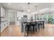 Modern kitchen with center island, sleek countertops, pendant lighting, and stainless appliances at 7532 Milford Pl, Douglasville, GA 30135