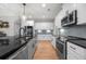 Contemporary kitchen featuring stainless steel appliances, ample cabinetry, and black countertops at 7532 Milford Pl, Douglasville, GA 30135