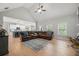 Open-concept living room with hardwood floors, high ceilings, and access to the kitchen at 7532 Milford Pl, Douglasville, GA 30135