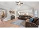 Open-concept living room showcasing vaulted ceiling, hardwood floors and cozy leather seating at 7532 Milford Pl, Douglasville, GA 30135