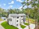 New construction featuring neutral colored siding, multiple windows and attached garages at 1695 Thomas St, Decatur, GA 30032