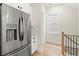 Modern kitchen with stainless steel refrigerator, white cabinets, and light hardwood flooring at 1695 Thomas St, Decatur, GA 30032