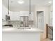 Stylish kitchen with modern appliances, white cabinets, quartz countertops, and stainless steel refrigerator at 1695 Thomas St, Decatur, GA 30032
