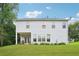 Back exterior of a two-story home with a covered porch and a spacious, green yard at 233 Hampton Station Blvd, Canton, GA 30115