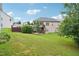 Large, grassy backyard featuring a two-story home with a deck and staircase at 233 Hampton Station Blvd, Canton, GA 30115