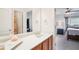 Bathroom featuring a vanity with a white countertop and mirror, a bedroom view, and towel racks at 233 Hampton Station Blvd, Canton, GA 30115