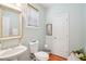 Stylish half bath showcasing a vessel sink, modern fixtures, and a neutral color palette with wood flooring at 233 Hampton Station Blvd, Canton, GA 30115