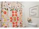 Bright bathroom showcases a floral shower curtain, toilet, and decorative letter art at 233 Hampton Station Blvd, Canton, GA 30115