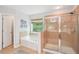Well-lit bathroom featuring a soaking tub, glass shower, and light tile throughout at 233 Hampton Station Blvd, Canton, GA 30115
