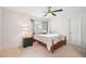 Comfortable bedroom featuring neutral carpet, a wooden-frame bed, and ample natural light at 233 Hampton Station Blvd, Canton, GA 30115
