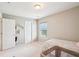 Spacious bedroom with two doors, a window with blinds, carpet flooring, and crib at 233 Hampton Station Blvd, Canton, GA 30115
