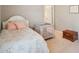 Bright bedroom features carpeted floors, a floral-patterned bed, and a cozy crib at 233 Hampton Station Blvd, Canton, GA 30115