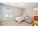 Cozy bedroom with carpeted floors, a window with blinds, and access to an en-suite bathroom at 233 Hampton Station Blvd, Canton, GA 30115
