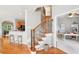 Inviting foyer features hardwood floors, a staircase with decorative iron spindles, and access to the kitchen and office space at 233 Hampton Station Blvd, Canton, GA 30115