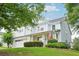 Inviting two-story home featuring a welcoming front porch and attached two-car garage at 233 Hampton Station Blvd, Canton, GA 30115