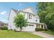 Charming two-story home with a covered front porch and attached two-car garage at 233 Hampton Station Blvd, Canton, GA 30115