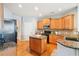 Charming kitchen features granite countertops, an island and stainless appliances against a neutral color scheme at 233 Hampton Station Blvd, Canton, GA 30115