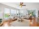 Cozy living room featuring hardwood floors, a ceiling fan, and lots of windows at 233 Hampton Station Blvd, Canton, GA 30115