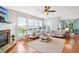 Bright living room with hardwood floors, stone fireplace, and lots of windows at 233 Hampton Station Blvd, Canton, GA 30115