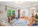 Inviting living room featuring a decorative bench, patterned rug, and ample natural light, creating a serene atmosphere at 233 Hampton Station Blvd, Canton, GA 30115