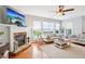 Bright living room featuring a stone fireplace, hardwood floors, and neutral decor at 233 Hampton Station Blvd, Canton, GA 30115
