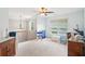 Spacious, sunlit loft area featuring neutral carpet, ceiling fan, and windows overlooking the backyard at 233 Hampton Station Blvd, Canton, GA 30115