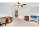 A spacious carpeted loft with ceiling fan, windows, and built-in desk and shelving at 233 Hampton Station Blvd, Canton, GA 30115