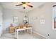 Bright office space with modern decor, featuring a ceiling fan and a large desk for workspace efficiency at 233 Hampton Station Blvd, Canton, GA 30115