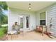 Covered back porch with charming decor, including seating and rustic furniture at 233 Hampton Station Blvd, Canton, GA 30115
