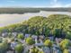An aerial view captures homes nestled among dense trees and a lake in the distance, showcasing a serene neighborhood at 358 Woodbrook Crst, Canton, GA 30114