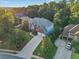 Aerial view of a home with a brick and siding facade, a long driveway, mature trees, and lush landscaping at 358 Woodbrook Crst, Canton, GA 30114