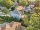 Aerial view features a house with a deck, a patio, mature trees and a manicured lawn at 358 Woodbrook Crst, Canton, GA 30114